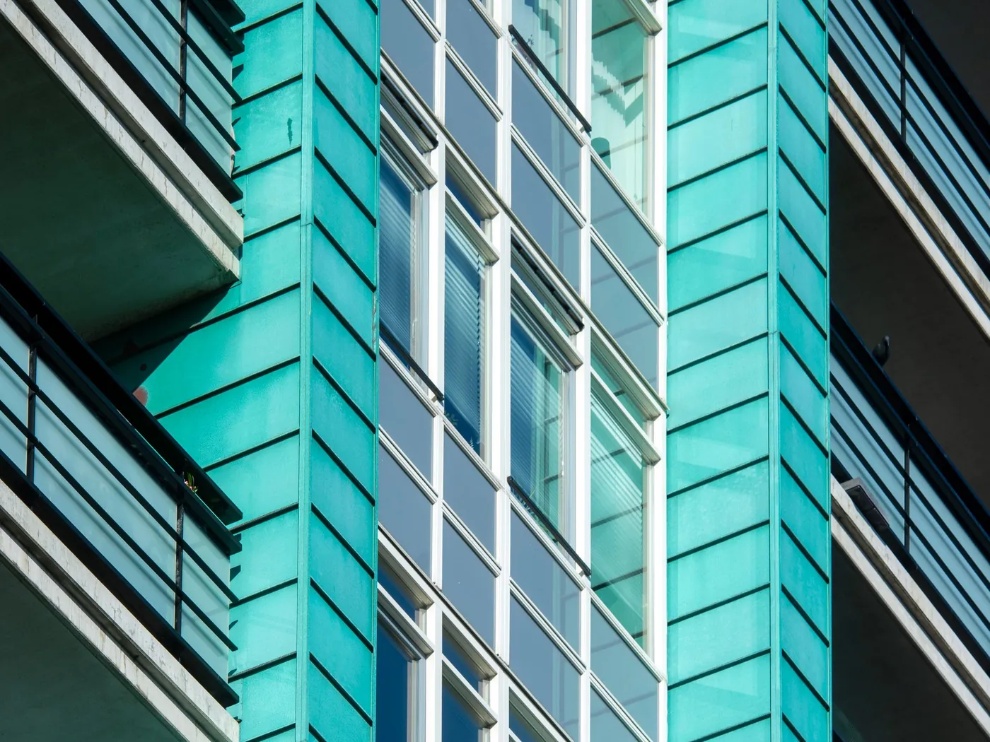 Teal metal cladding panels on a modern residential building
